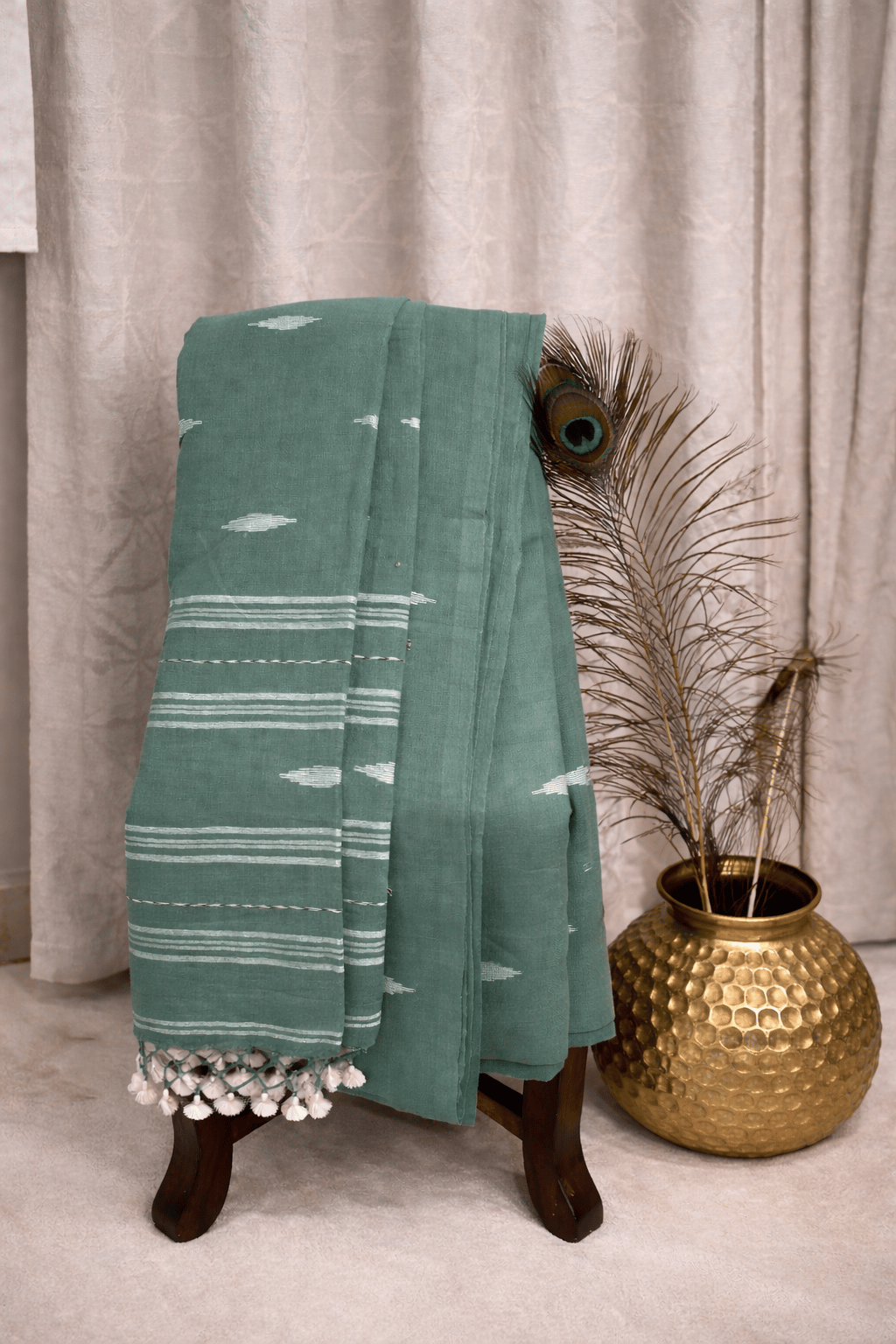 Sage green cotton saree with white motifs, striped border and tassel pallu