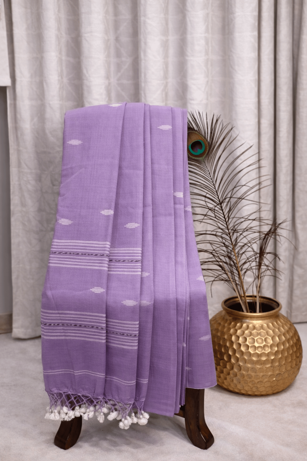 Light lavender cotton saree with white woven motifs, striped border and tassel pallu