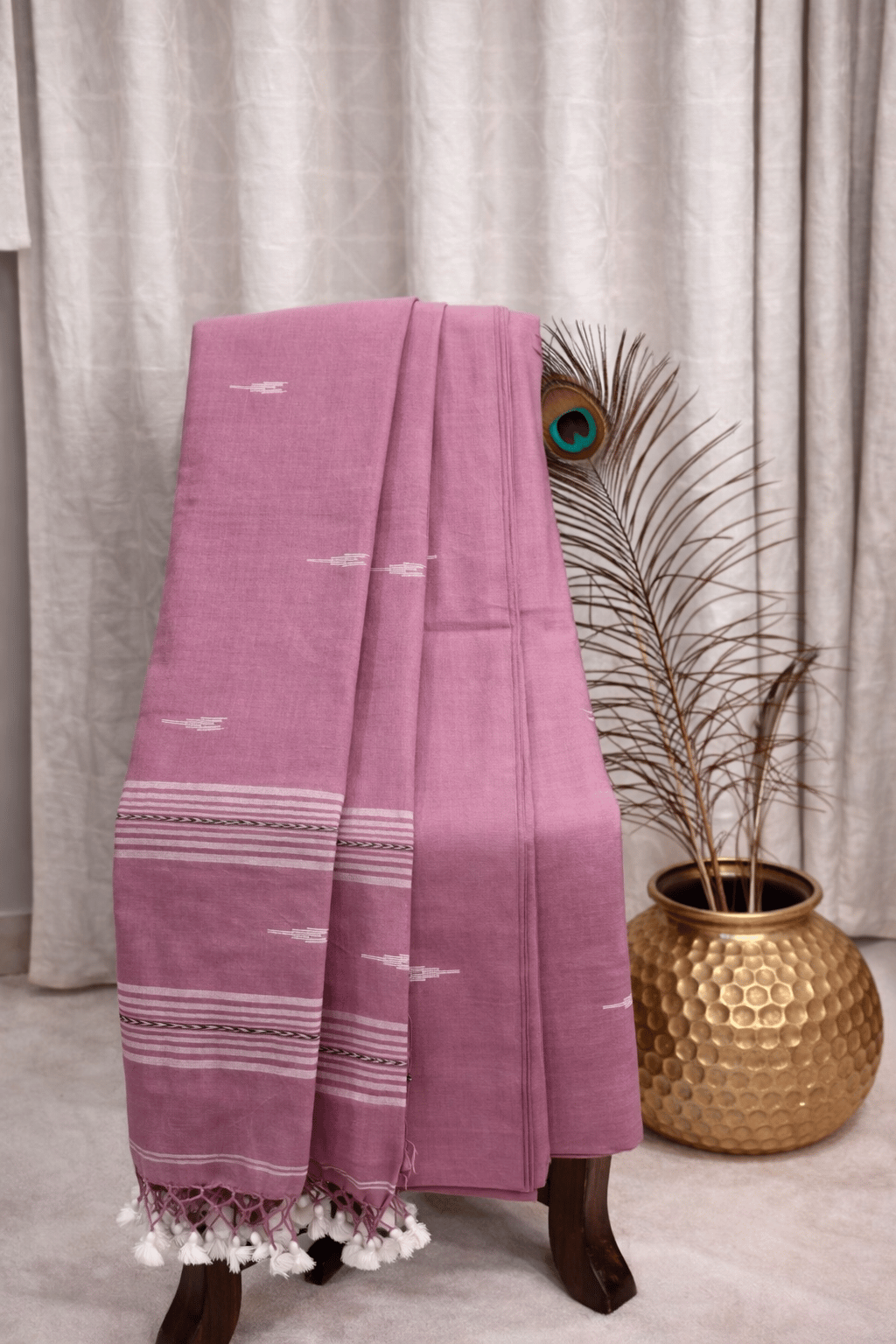 Dusty pink cotton saree with white woven motifs, striped border and tassel pallu