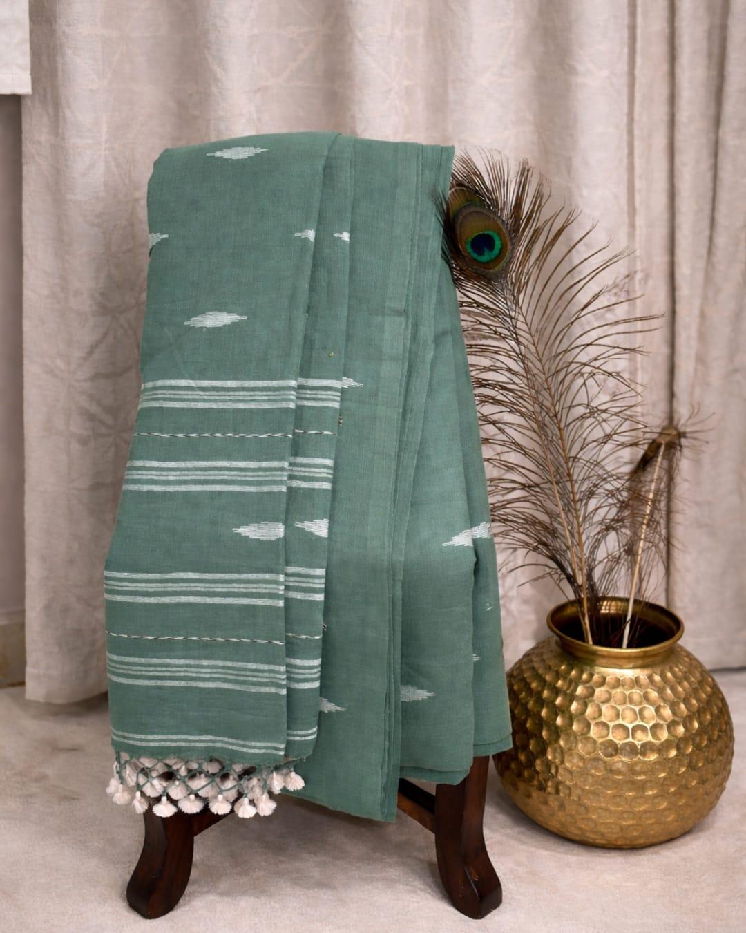 Sage green cotton saree with white motifs, striped border and tassel pallu