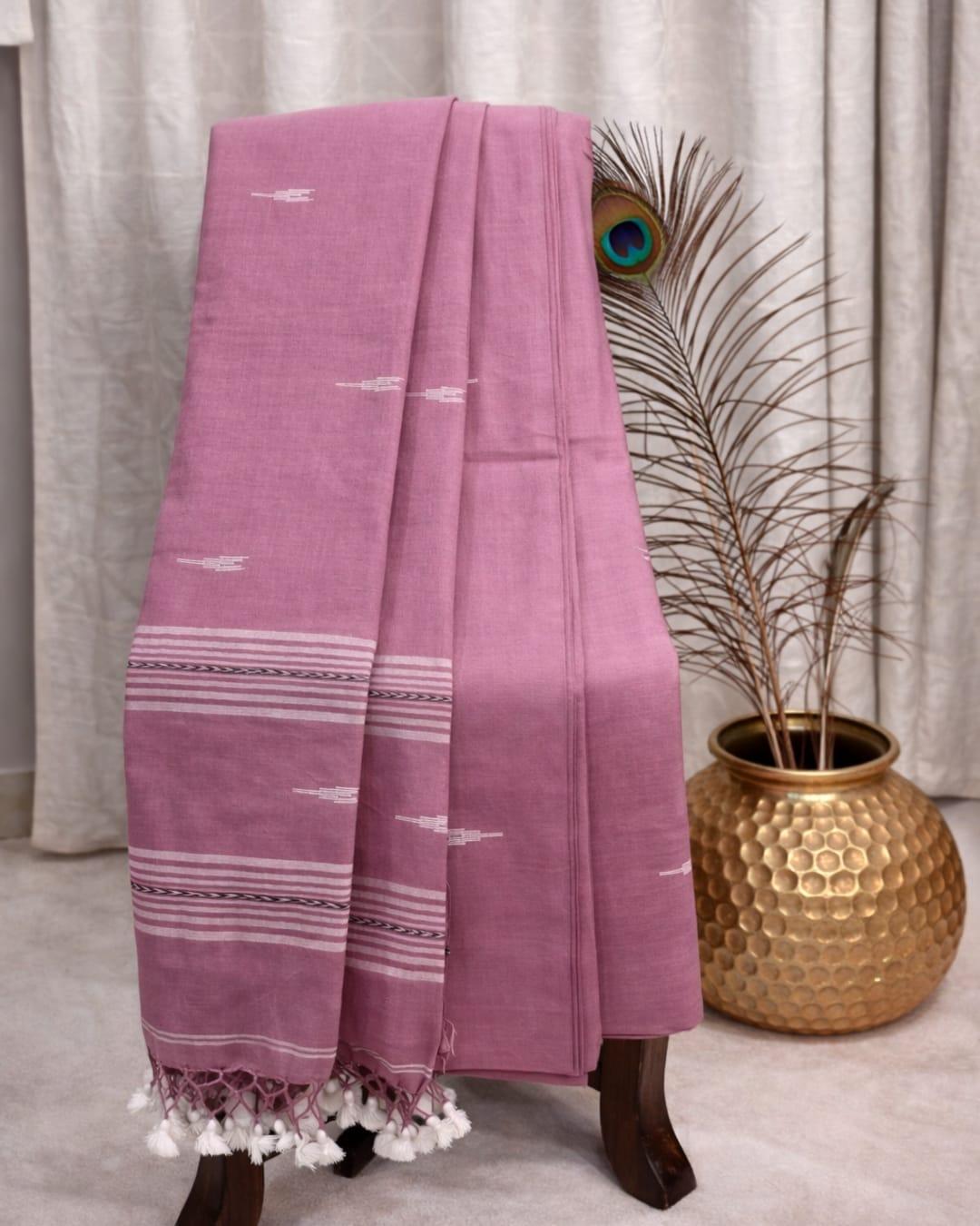 Dusty pink cotton saree with white woven motifs, striped border and tassel pallu